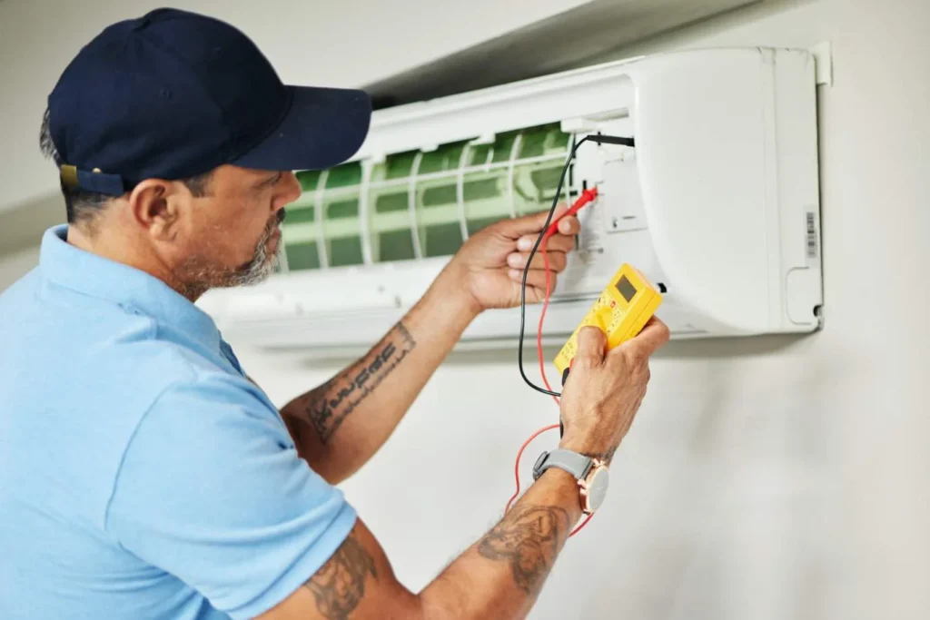 HVAC technician servicing air conditioner in Wood-Ridge, NJ
